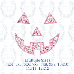 May include: An embroidery design featuring a jack-o'-lantern face composed of two triangular eyes, a triangular nose, and a jagged mouth, all filled with a pink, red, and green floral pattern. Text below reads: Multiple Sizes 4x4, 5x5, 6x6, 7x7, 8x8, 9x9, 10x10, 11x11, 12x12.