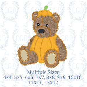 May include: An embroidery design of a brown teddy bear wearing a yellow pumpkin costume with a green stem on its head. The bear has beige paw pads and a black nose. Text below reads: Multiple Sizes 4x4, 5x5, 6x6, 7x7, 8x8, 9x9, 10x10, 11x11, 12x12.