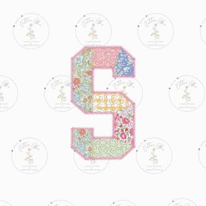 May include: A patchwork fabric applique of the letter S in pink, blue, green, and yellow floral patterns. The letter is outlined in pink stitching.