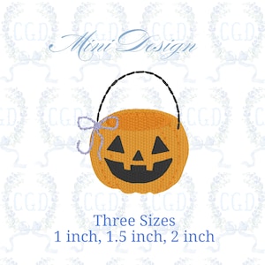 May include: An orange pumpkin-shaped basket with a black handle and a smiling face. A purple bow is tied to the side. The text "Mini Design" is above the basket, and "Three Sizes" with size measurements of 2.5, 3.8, and 5.1 cm are below.