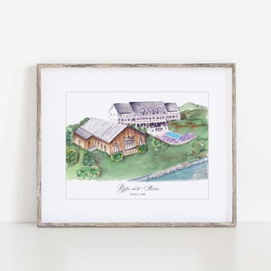 May include: Watercolor painting of a venue with two buildings, a pool, and landscaping. The artwork is framed in a light wood frame. The names "Rylie and Stevie" and the date "June 6, 2024" are written on the artwork.