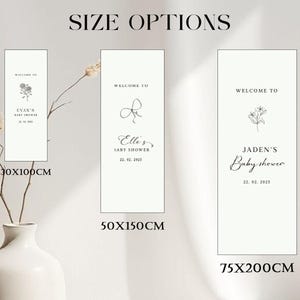 May include: White rectangular baby shower welcome signs with floral and script text. Sizes include 30x100cm, 50x150cm, and 75x200cm. The signs feature names and dates, with a minimalist design. The text "SIZE OPTIONS" is at the top.