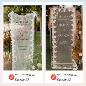 May include: Two wedding welcome signs, each 75cm x 200cm, with lace trim and text. One says "Welcome" and the names "Amelia + Rorschach" with a date. The other says "Welcome" and the names "Bailey & Oliver" with a date.