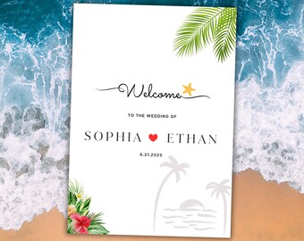 May include: A white wedding welcome sign with a tropical theme. The sign says "Welcome to the wedding of Sophia and Ethan" with a red heart between the names. The date 6.21.2025 is below the names. The sign has a palm tree silhouette and a sunset on the bottom. There are tropical leaves and flowers in the bottom left corner.