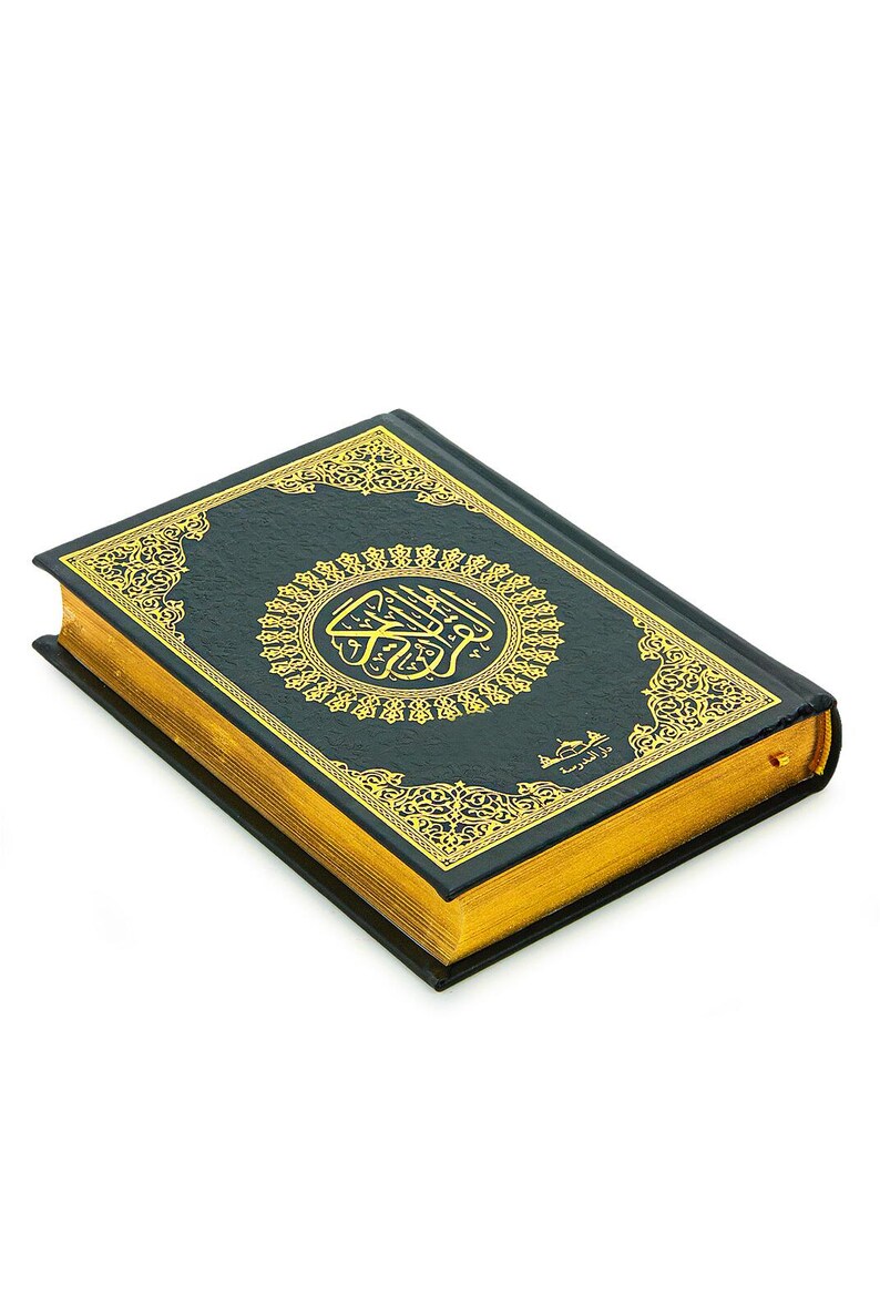 May include: A hardcover book with a dark teal cover and gold gilded edges. The cover features ornate gold filigree and a central circular emblem. The book's spine is black, and the pages are gold. The book is set against a white background.