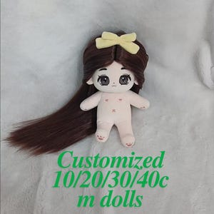 May include: A brown haired doll with a yellow bow in her hair. The doll is wearing a nude colored outfit and has a sweet expression on her face. The doll is 10/20/30/40 cm tall.  The text "Customized 10/20/30/40c m dolls" is written below the doll.