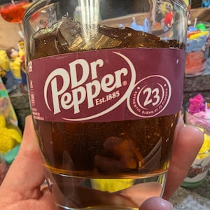 Dr pepper scented candle in a glass cup