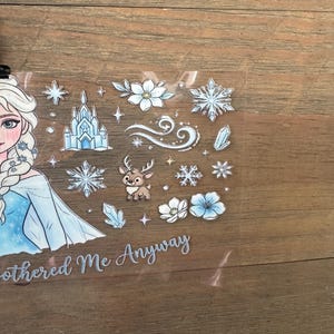 May include: A clear sticker sheet featuring a cartoon illustration of a princess in a blue dress, snowflakes, a castle, flowers, and a reindeer. The text "Bothered Me Anyway" is also included.
