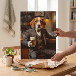 May include: A rectangular wall art print featuring a beagle with brown and white fur wearing a brown pinstripe suit, vest, and bow tie. The dog sits at a bar holding a glass of beer, with a sign on the wall that reads buddy's bar in script.