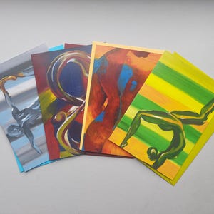 May include: Set of five art cards featuring abstract paintings in various colors, including blue, green, yellow, red, and orange. The cards depict different abstract shapes and figures.