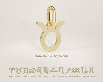 May include: A gold-colored Taurus charm in 14k yellow gold. The charm features the Taurus zodiac symbol with a connecting loop. Below are other zodiac symbols with their names: Aries, Gemini, Cancer, Leo, Virgo, Libra, Scorpio, Sagittarius, Aquarius, Capricorn, and Pisces.