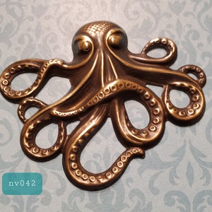 May include: A gold-toned metal octopus figurine with detailed tentacles and a textured surface.