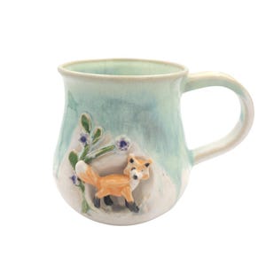 Cozy Fox Mug Irish handmade pottery cute fox design trotting to den with floral details.Turquoise colour perfect for coffee tea drinker