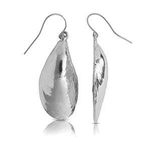 May include: A pair of silver teardrop-shaped earrings with a smooth, textured finish.
