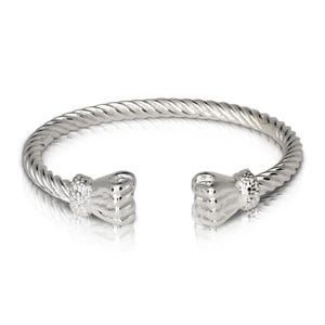 May include: Silver bracelet with a twisted rope design and two fist-shaped ends.