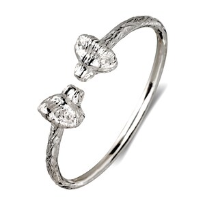 May include: A silver-toned cuff bracelet featuring ram head designs at each end. The bracelet has an open design, allowing for easy wear. The ram heads are detailed with textured surfaces, and the band has a subtle etched pattern.
