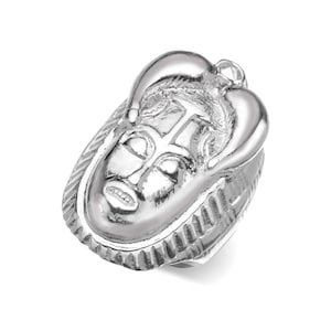 May include: A silver ring with a detailed design of a face with horns. The ring is made of metal and has a textured surface.