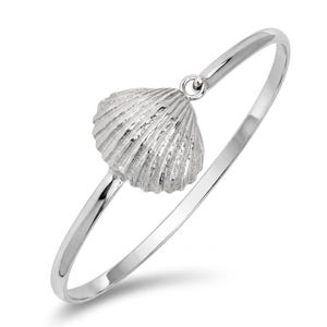 May include: A polished silver-tone bangle bracelet featuring a single, textured seashell charm suspended from a small circular loop. The metal surface has a bright, reflective finish, and the shell charm displays detailed, radiating ridges.