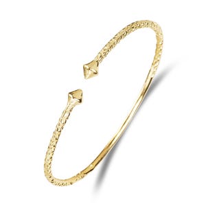 May include: A gold-colored open cuff bracelet. The bracelet has a textured surface and pointed ends. The open design allows for easy wear. The jewelry is displayed on a white background.
