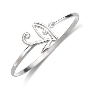 May include: Silver bracelet with an Eye of Horus charm. The charm is a detailed outline of the eye with a small circle in the center.