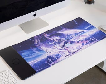 May include: A large, rectangular mouse pad with a black border and a colorful anime-style design featuring a female character with wings and a starry sky background.
