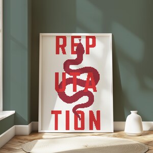 May include: White framed canvas print with the word "REPUTATION" in red letters, with a red snake design incorporated into the letters.