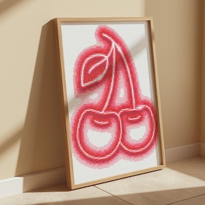 May include: A framed cross-stitch artwork depicting a pair of red cherries with a stem and leaf. The cherries are outlined in a bright pink colour, creating a neon effect.