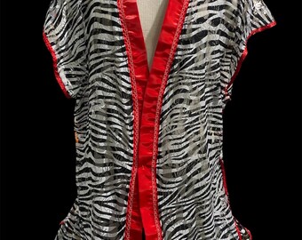 May include: A sheer black and white zebra print robe with a red satin trim and a tie closure.