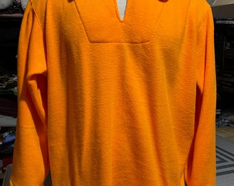 May include: A bright orange long-sleeved shirt with a V-neck and a collar. The shirt has a textured, fuzzy surface.