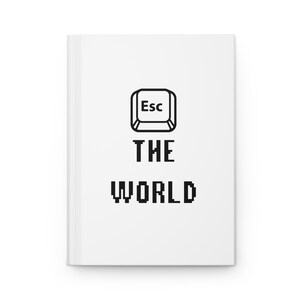 May include: White notebook with a black and white illustration of an escape key and the text "THE WORLD" in black.