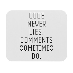 May include: A white mousepad with black text that reads "CODE NEVER LIES, COMMENTS SOMETIMES DO."