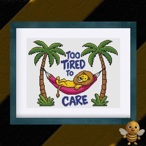 May include: A cross-stitch pattern featuring a lion relaxing in a hammock between two palm trees. The text "Too Tired To Care" is written in blue letters above the lion.