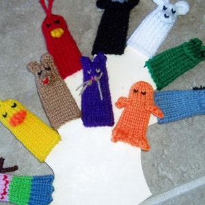 May include: A set of ten finger puppets, each with a different animal design. The puppets are made of knitted yarn in various colors, including red, blue, green, orange, yellow, brown, and white. The puppets are all about 4 inches tall and have a finger hole at the bottom.