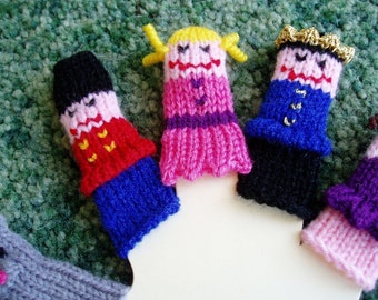May include: Five knitted finger puppets, each with a different design and color. The puppets include a girl with yellow hair and a pink dress, a boy with a blue and black outfit, a girl with a purple and pink dress, a boy with a blue and black outfit, and a girl with a purple and pink dress.