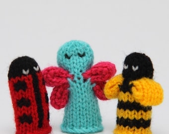 May include: Three knitted finger puppets: a ladybug with black spots, a blue butterfly with pink wings, and a yellow and black bee.