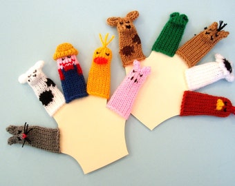 May include: A set of ten finger puppets featuring various farm animals, including a pig, cow, rooster, chicken, and dog. The puppets are made of knitted yarn in a variety of colors, including pink, white, red, brown, and yellow.