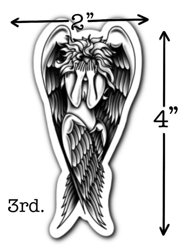 May include: A black and white sticker featuring an angel with hands covering its face. The sticker is 4 inches tall and 2 inches wide. The text "3rd." is at the bottom of the sticker.