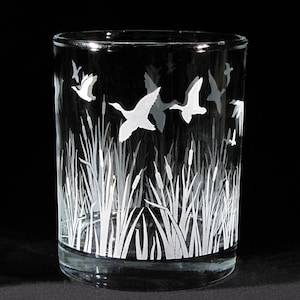 May include: A clear glass tumbler with a white etched design of flying geese and cattails.