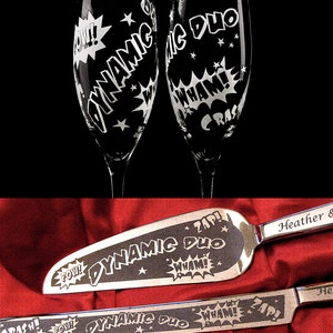 A set of two champagne flutes and a cake server with a comic book theme. The glasses and server are engraved with the words "Dynamic Duo" and various comic book sound effects like "Pow!" and "Zap!"