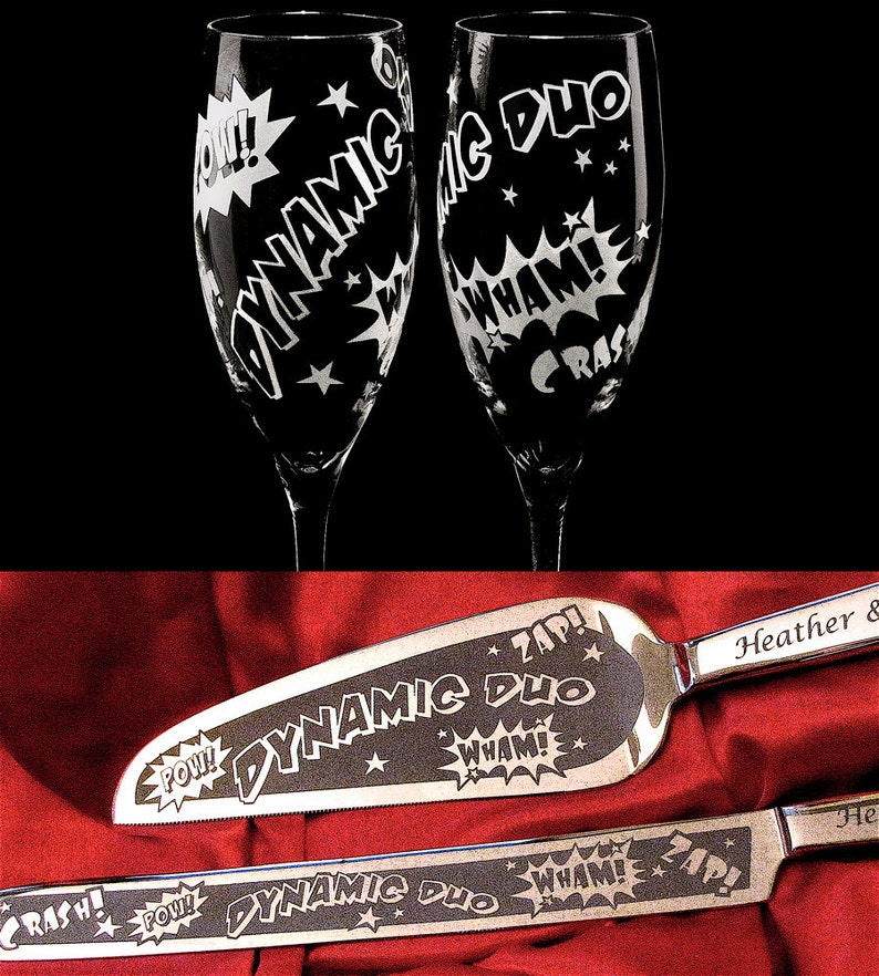 A set of two champagne flutes and a cake server with a comic book theme. The glasses and server are engraved with the words "Dynamic Duo" and various comic book sound effects like "Pow!" and "Zap!"