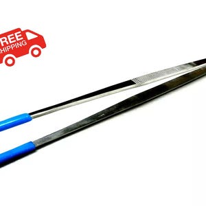 May include: A pair of stainless steel tweezers with blue rubber tips. The tweezers are closed and lying flat on a white surface.