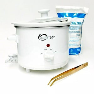 May include: White electric slow cooker with a glass lid and a knob with settings for off, low, high, and auto. The cooker is on a white surface with a pair of gold tweezers and a bag of dry acid compound.