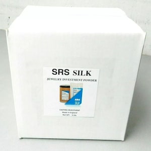 May include: White cardboard box with a label that reads "SRS SILK Jewellery Investment Powder". The label also shows two containers of the powder and the text "Casting Investment Made in England Net WT: 5 Lbs".