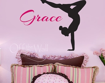 May include: A pink wall with a black silhouette of a gymnast doing a handstand. The name "Grace" is written in pink cursive above the gymnast.