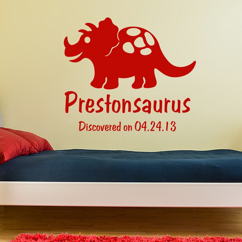 May include: Red dinosaur wall decal with white spots, featuring the name "Prestonsaurus" and the text "Discovered on 04.24.13".