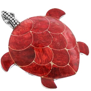 May include: A red turtle pendant with a silver head and a detailed shell design. The shell is made of red and white mosaic tiles.
