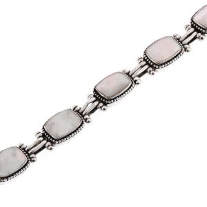 May include: A silver bracelet featuring rectangular, iridescent, light-colored stones. Each stone is framed with a beaded border and connected by silver links. The bracelet is displayed against a white background.