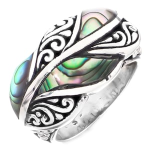 May include: A silver ring with an abalone shell inlay and intricate scrollwork design.