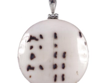 May include: A round, white shell pendant with a silver bail. The shell has a natural pattern of black markings.