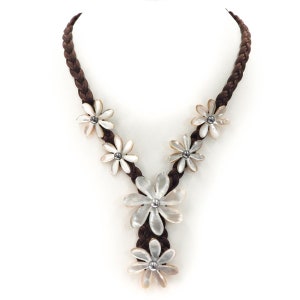 May include: A brown braided cord necklace with five white flower-shaped pendants. Each pendant has a small silver bead in the centre.